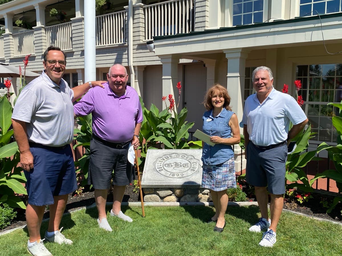 Members posing by the Bellevue Golf Club sign