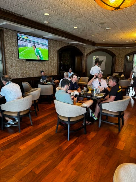 The group relaxing in the clubhouse after the round