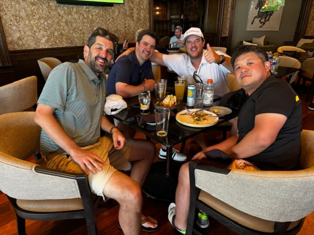 A foursome gathered around the table at the clubhouse