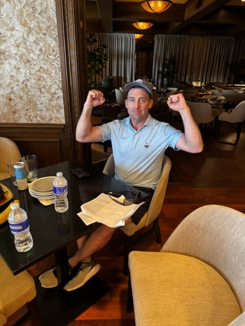 A member celebrating a great day at Saratoga National