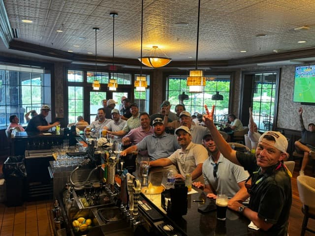 The group gathers at the clubhouse bar